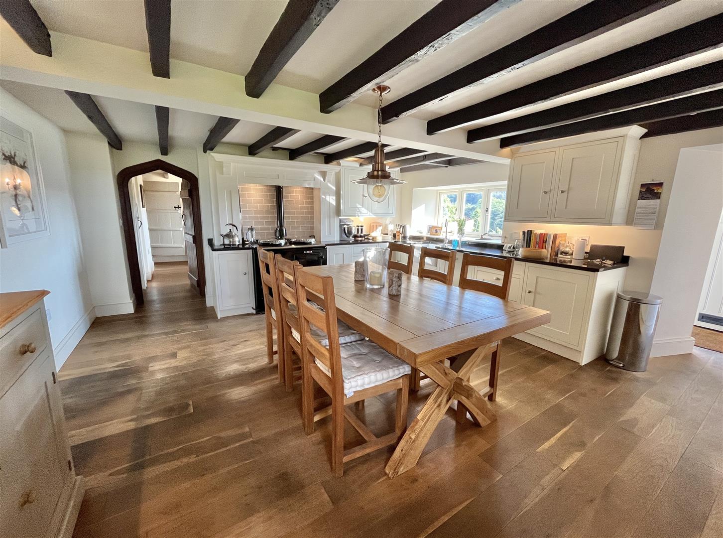 Farmhouse kitchen-diner with exposed beams, AGA and a copper pendant light