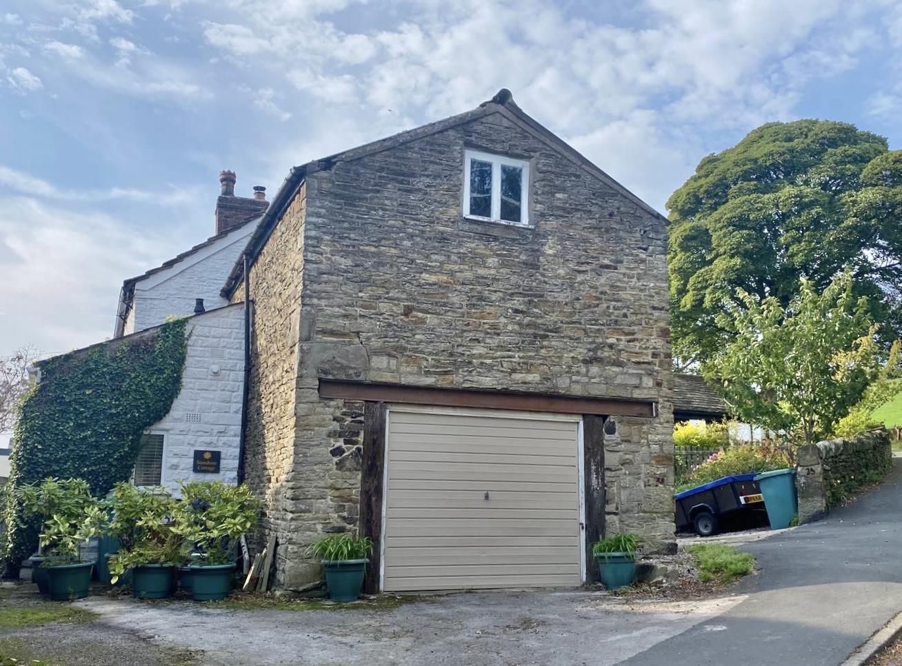 Two-storey stone barn and garage at the Church Road property