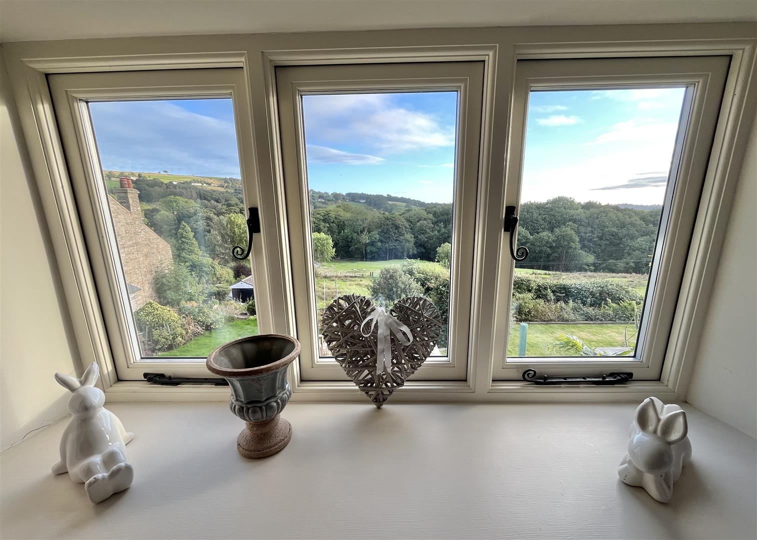 Countryside viewed through a casement window