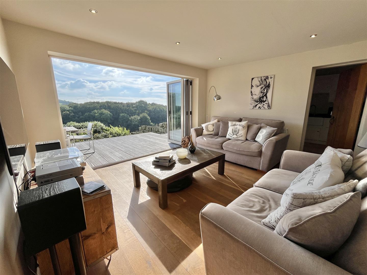 The sunroom with bi-fold doors folded back onto the raised deck