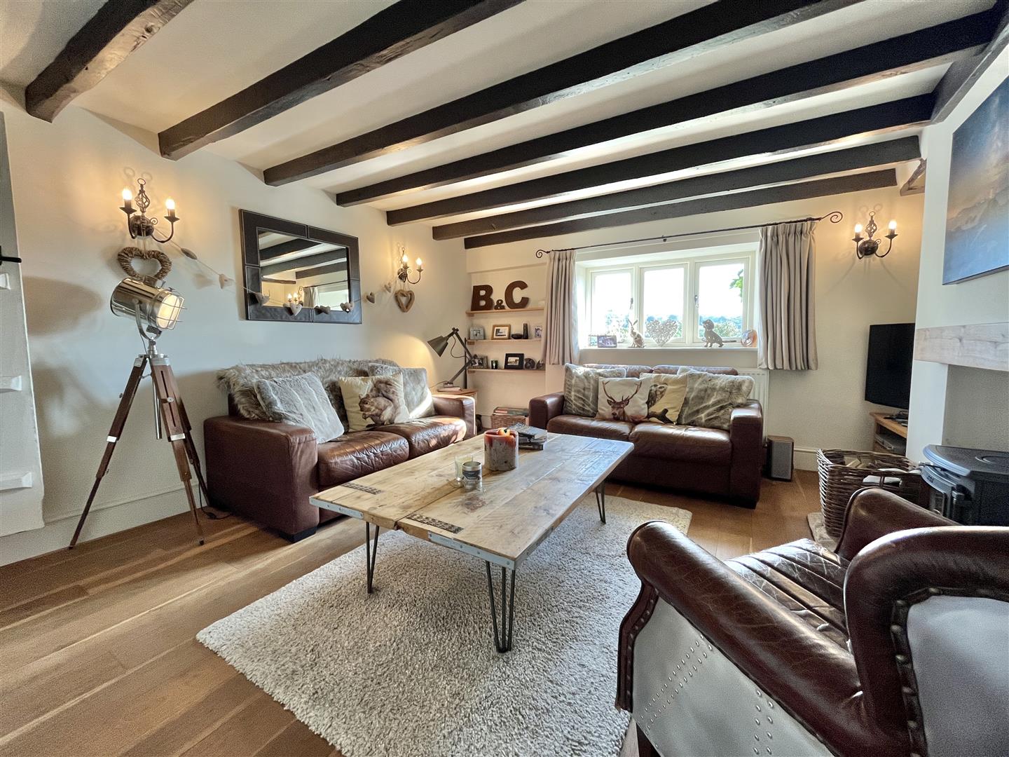 The snug with exposed ceiling beams and a wood-burning stove