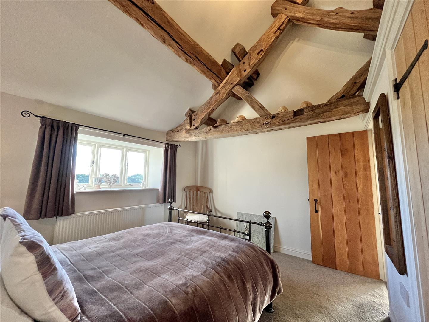 Vaulted bedroom with exposed roof timbers